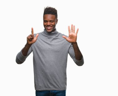 Gösterilen ve parmakları ile işaret izole arka plan üzerinde genç Afro-Amerikan adam kendinden emin ve mutlu gülümseyerek süre yedi numara.