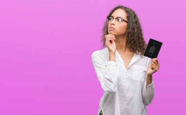 Genç İspanyol kadın holding pasaport Kanada ciddi bir yüz düşünce soru çok karışık fikir hakkında