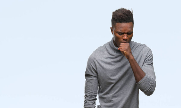 Young african american man over isolated background feeling unwell and coughing as symptom for cold or bronchitis. Healthcare concept.