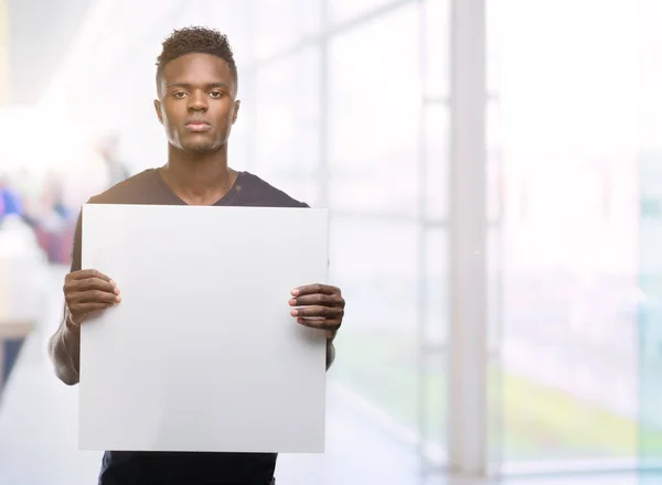 Young African American Man Holding Banner Confident Expression Smart Face — Stock Photo, Image