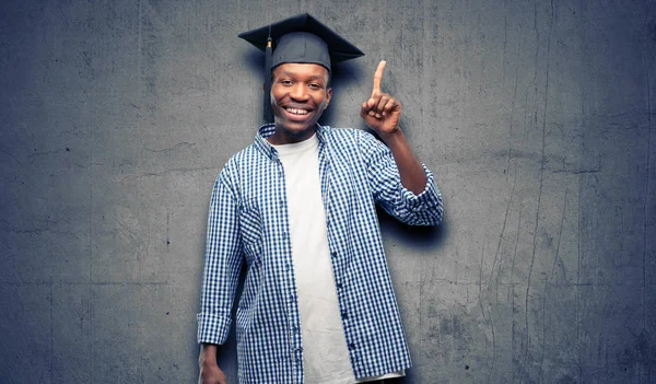 Young african graduate student black man pointing away side with finger