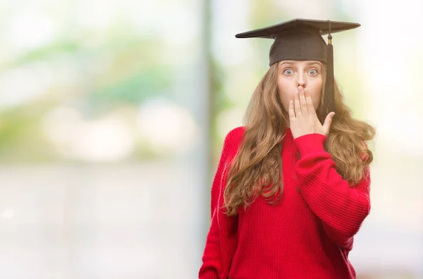 Young Blonde Woman Wearing Graduation Cap Cover Mouth Hand Shocked — Stock Photo, Image