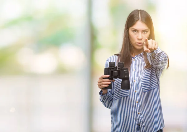 Young Hispanic Woman Holding Binoculars Pointing Finger Camera You Hand — Stock Photo, Image