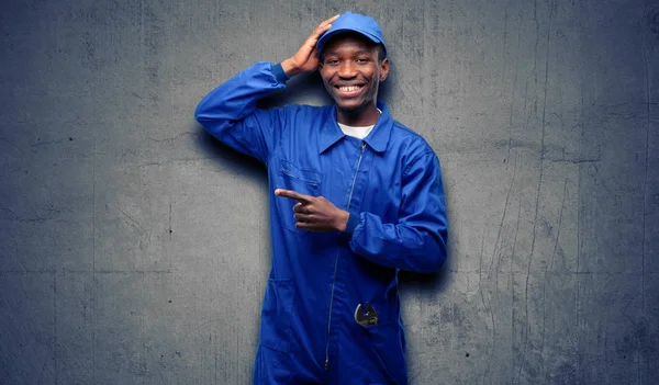 African black plumber man pointing away side with finger