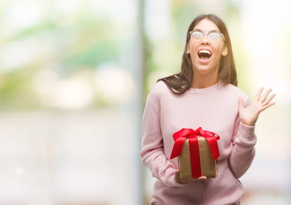 Young Hispanic Woman Holding Gift Very Happy Excited Winner Expression — Stock Photo, Image