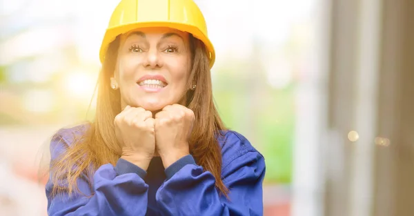 Engineer construction worker woman terrified and nervous expressing anxiety and panic gesture, overwhelmed