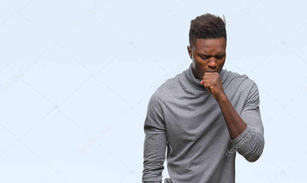 Young african american man over isolated background feeling unwell and coughing as symptom for cold or bronchitis. Healthcare concept.
