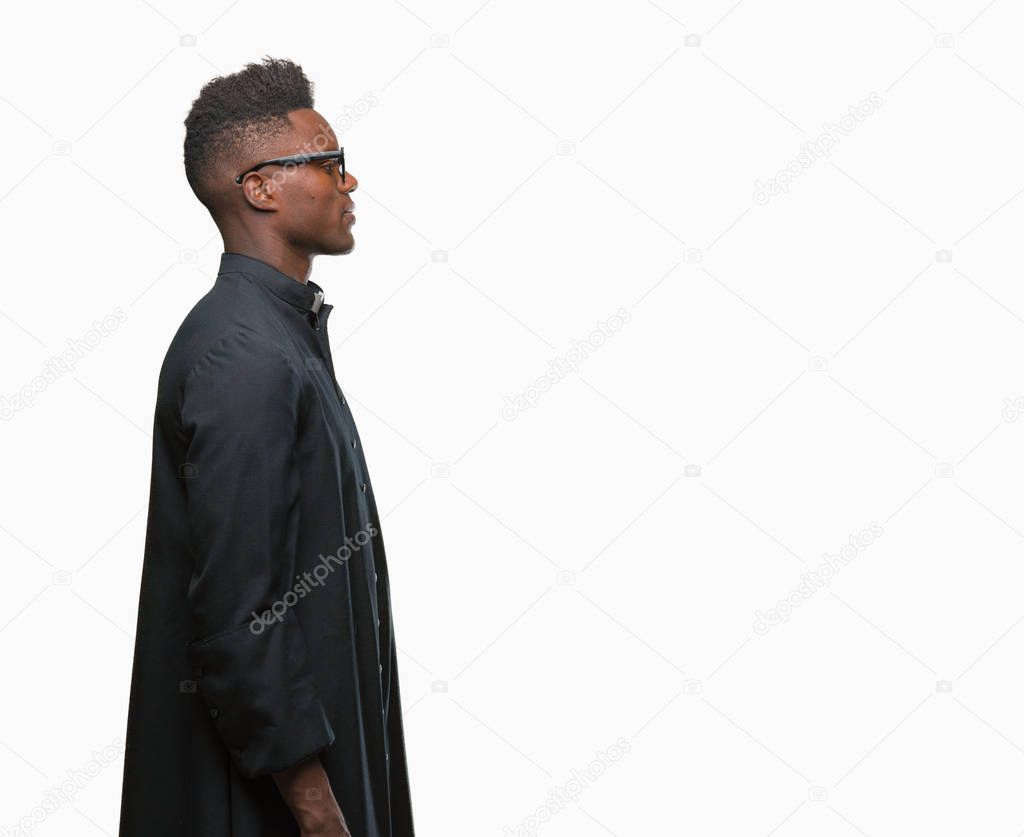 Young african american priest man over isolated background looking to side, relax profile pose with natural face with confident smile.
