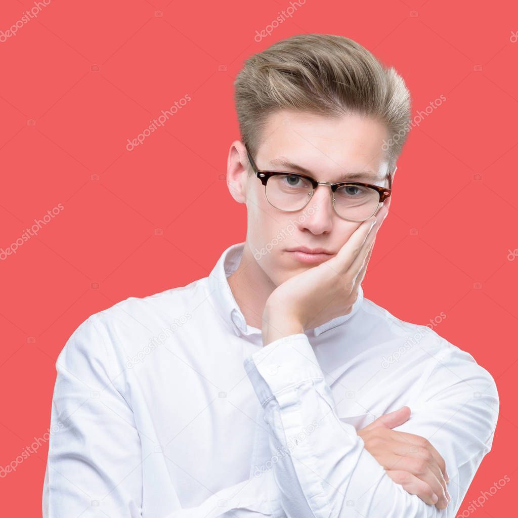 Young handsome blond man thinking looking tired and bored with depression problems with crossed arms.