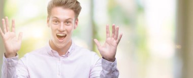 Genç yakışıklı sarışın adam çok mutlu ve heyecanlı, kazanan ifade büyük gülümseme ile çığlık ve ellerini kaldırdı zaferini kutluyor