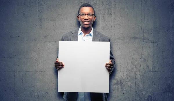 African black man wearing jacket holding blank advertising banner, good poster for ad, offer or announcement, big paper billboard