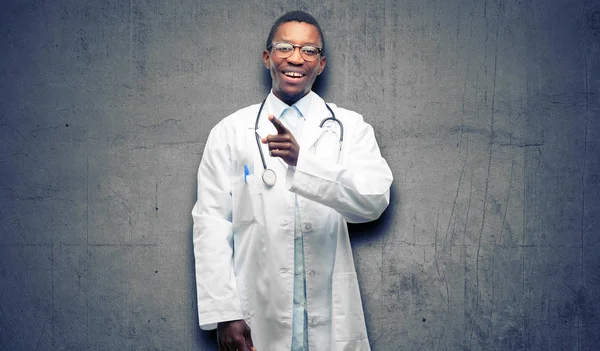 Young black doctor, medical professional pointing away side with finger