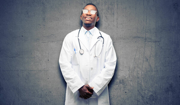 Young black doctor, medical professional thinking and looking up expressing doubt and wonder