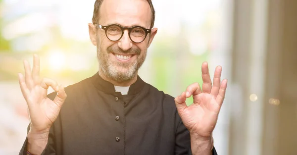 Priest religion man doing ok sign gesture with both hands expressing meditation and relaxation