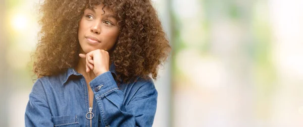 African American Woman Wearing Blue Jumpsuit Thinking Looking Expressing Doubt — Stock Photo, Image