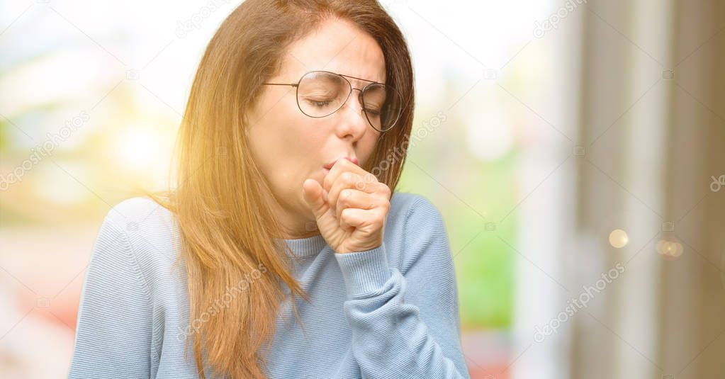 Middle age woman wearing wool sweater and cool glasses sick and coughing, suffering asthma or bronchitis, medicine concept