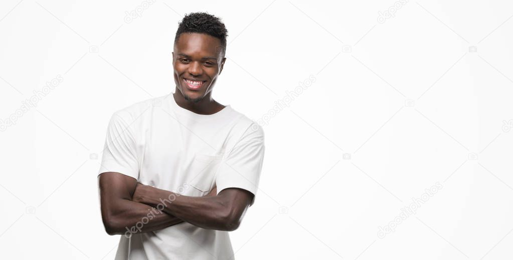 Young african american man wearing white t-shirt happy face smiling with crossed arms looking at the camera. Positive person.