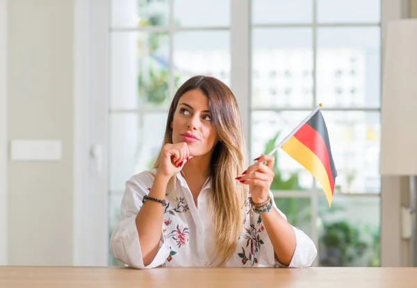Young Woman Home Holding Flag Germany Serious Face Thinking Question — Stock Photo, Image