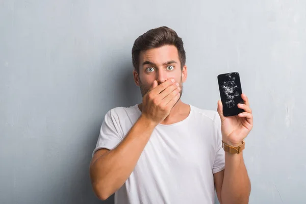 Handsome Young Man Grey Grunge Wall Showing Broken Smartphone Screen — Stock Photo, Image
