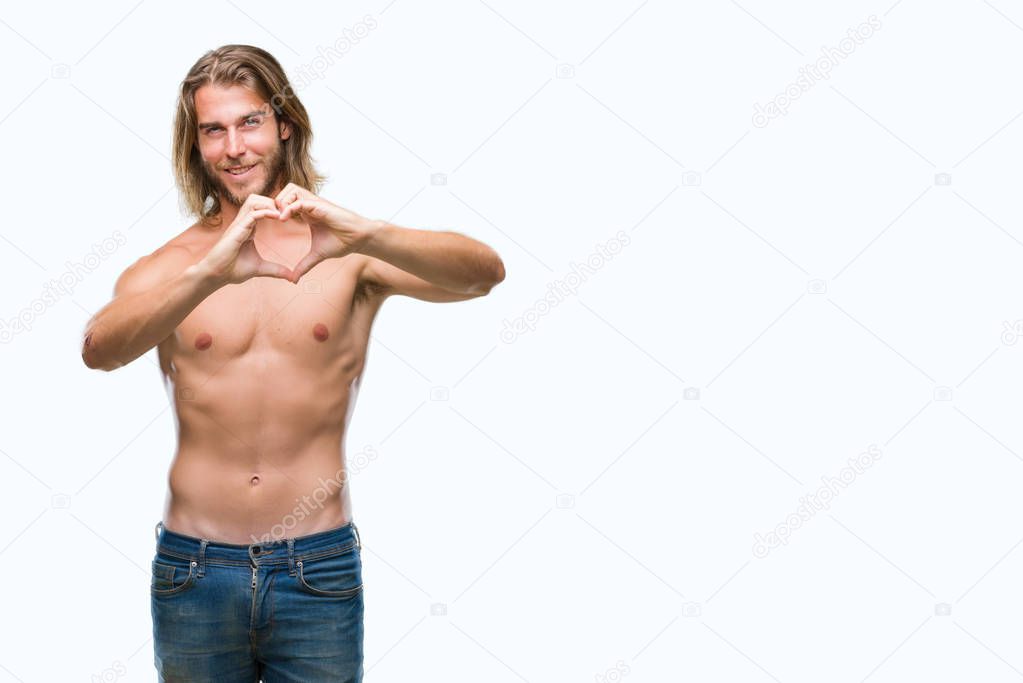 Young handsome shirtless man with long hair showing sexy body over isolated background smiling in love showing heart symbol and shape with hands. Romantic concept.