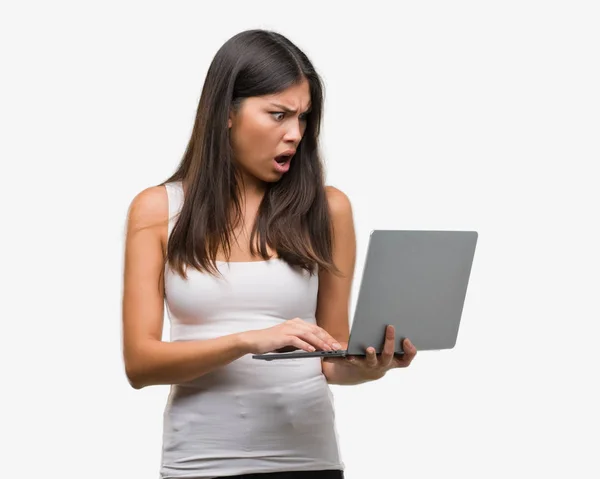 Young Hispanic Woman Using Computer Laptop Scared Shock Surprise Face Royalty Free Stock Images