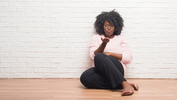 Young African American Woman Sitting Floor Home Looking Camera Blowing — Stock Photo, Image