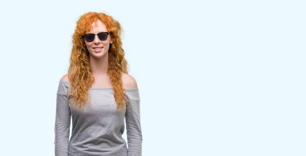 Young Redhead Woman Wearing Sunglasses Happy Face Standing Smiling Confident — Stock Photo, Image