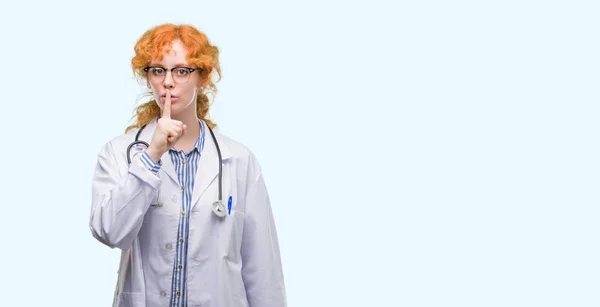 Young Redhead Woman Wearing Doctor Uniform Asking Quiet Finger Lips — Stock Photo, Image