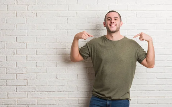 Joven Hombre Caucásico Pie Sobre Pared Ladrillo Blanco Mirando Confiado — Foto de Stock