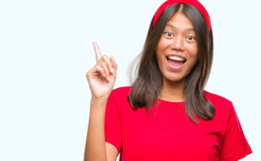 Genç Asyalı kadın ile başarılı fikir parmağı yukarıyı izole arka plan üzerinde. Çıktıktan ve mutlu. Bir numara.