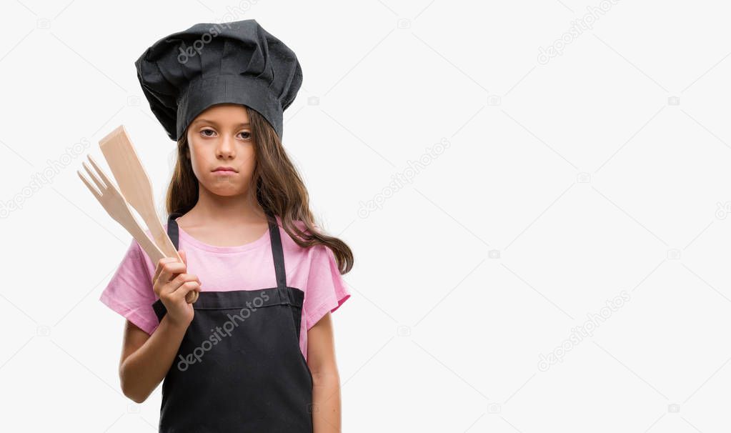 Brunette hispanic girl wearing cook uniform with a confident expression on smart face thinking serious