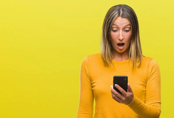 Young Beautiful Woman Sending Message Using Smartphone Isolated Background Scared — Stock Photo, Image