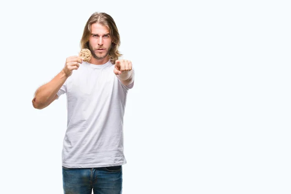 Young Handsome Man Long Hair Eating Chocolate Cooky Isolated Background — Stock Photo, Image