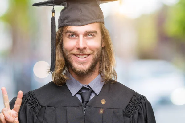 Young Handsome Graduated Man Long Hair Isolated Background Showing Pointing — Stock Photo, Image