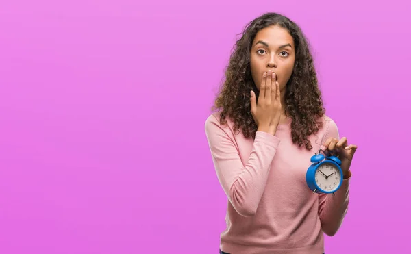Young Hispanic Woman Holding Alarm Clock Cover Mouth Hand Shocked — Stock Photo, Image