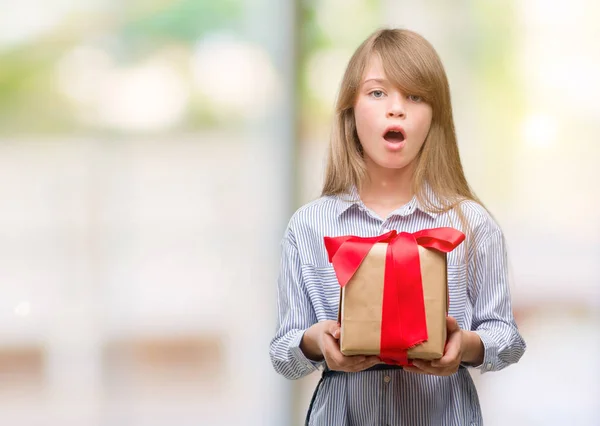 Young Blonde Toddler Holding Present Scared Shock Surprise Face Afraid — Stock Photo, Image