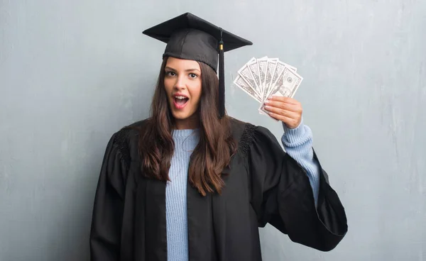 Young Brunette Woman Grunge Grey Wall Wearing Graduate Uniform Holding — Stock Photo, Image