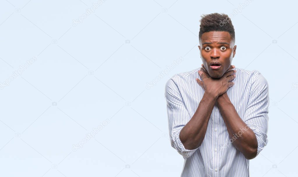 Young african american man over isolated background shouting and suffocate because painful strangle. Health problem. Asphyxiate and suicide concept.