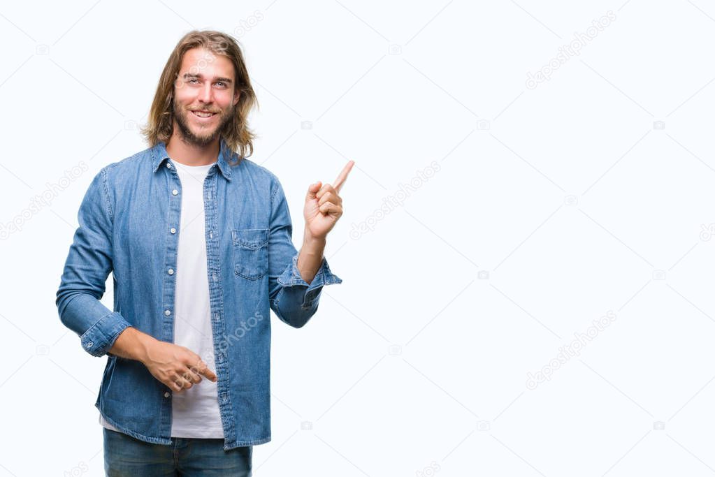 Young handsome man with long hair over isolated background with a big smile on face, pointing with hand and finger to the side looking at the camera.
