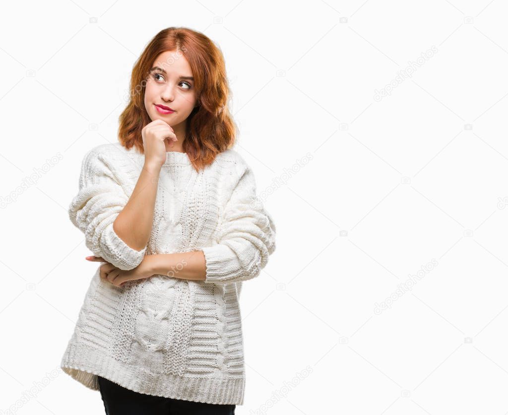 Young beautiful woman over isolated background wearing winter sweater with hand on chin thinking about question, pensive expression. Smiling with thoughtful face. Doubt concept.