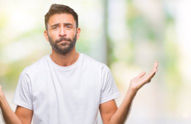 Adult hispanic man over isolated background clueless and confused expression with arms and hands raised. Doubt concept. clipart