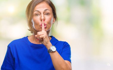 Orta yaş İspanyol kadın kıdemli dudaklarında parmak ile sessiz olmanı izole arka plan üzerinde. Sessizlik ve gizli kavramı.