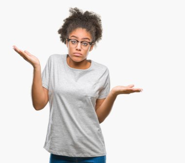 Young afro american woman wearing glasses over isolated background clueless and confused expression with arms and hands raised. Doubt concept. clipart