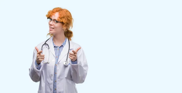 Young Redhead Woman Wearing Doctor Uniform Pointing Fingers Camera Happy — Stock Photo, Image