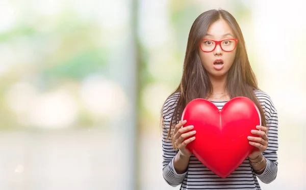 Junge Asiatische Verliebte Frau Hält Leseherz Über Isoliertem Hintergrund Erschrocken — Stockfoto