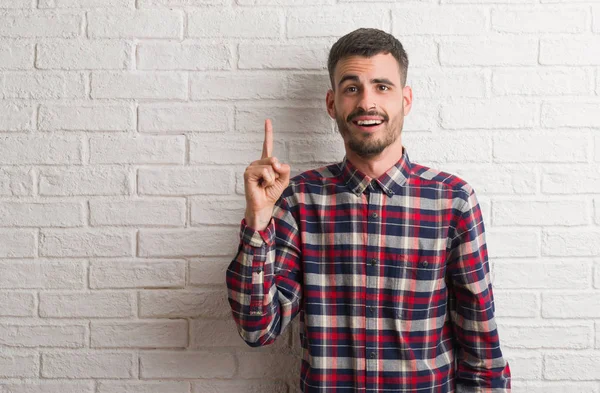 Young Adult Man Standing White Brick Wall Pointing Finger Successful — Stock Photo, Image