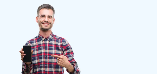 Young Hipster Adult Man Holding Smartphone Very Happy Pointing Hand — Stock Photo, Image