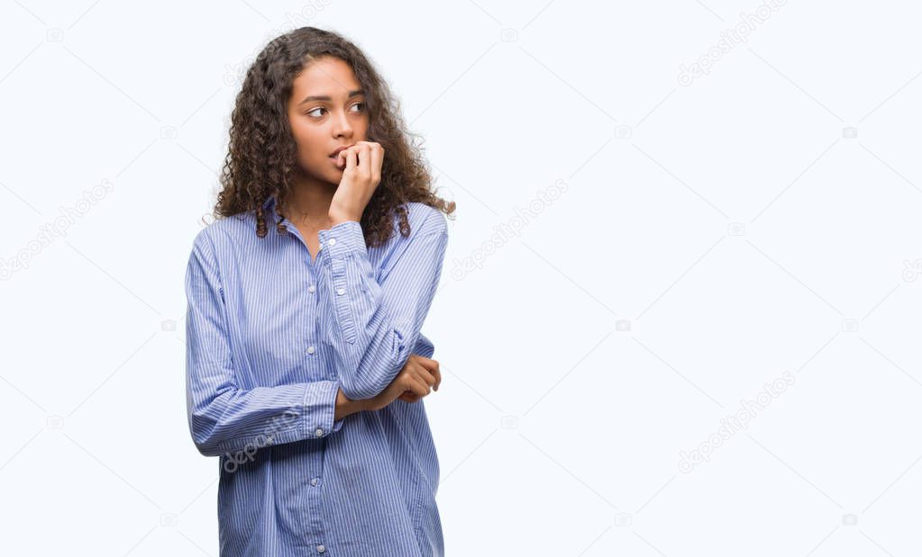 Young hispanic business woman looking stressed and nervous with hands on mouth biting nails. Anxiety problem.