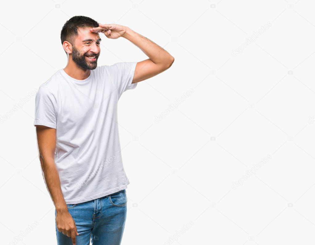 Adult hispanic man over isolated background very happy and smiling looking far away with hand over head. Searching concept.