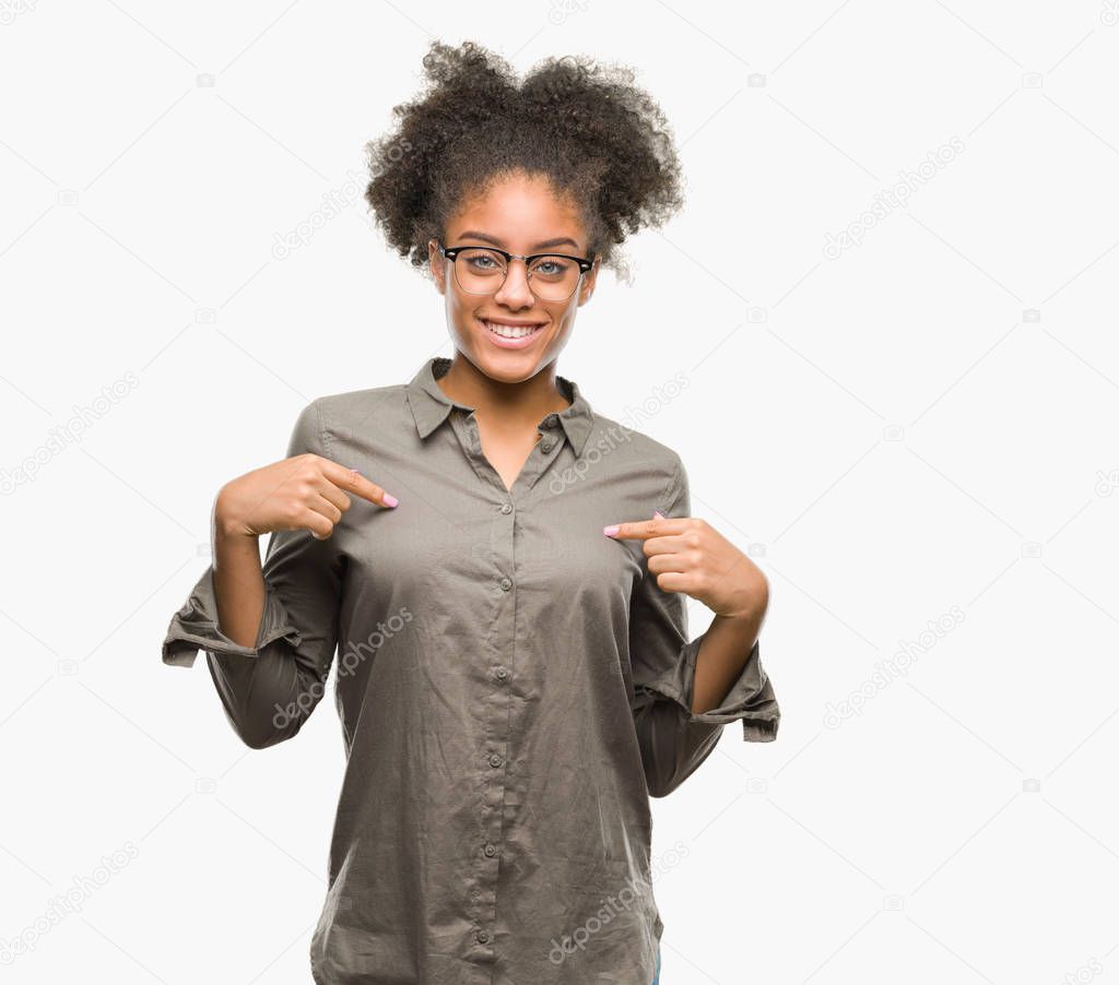 Young afro american woman wearing glasses over isolated background looking confident with smile on face, pointing oneself with fingers proud and happy.